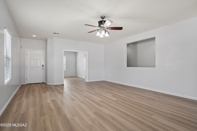 21700 E Governor Dr, Red Rock, AZ 85145 - unfurnished living room featuring visible vents, baseboards, a ceiling fan, and light wood finished floors
