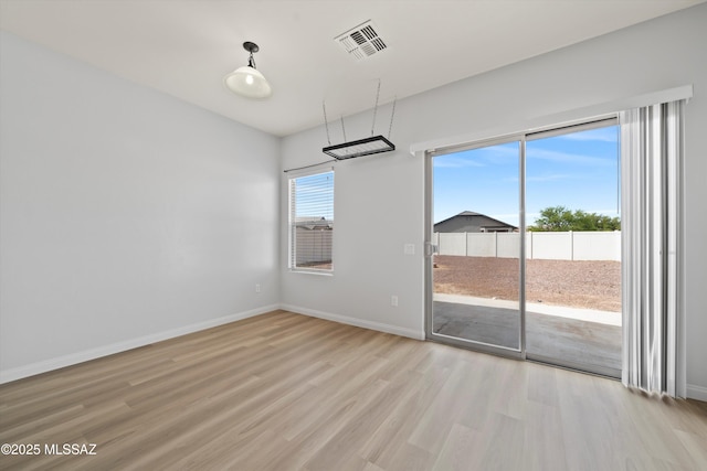 21700 E Governor Dr, Red Rock, AZ 85145 - unfurnished dining area featuring light wood-style floors, visible vents, and baseboards
