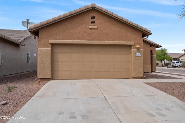 21700 E Governor Dr, Red Rock, AZ 85145 - view of front of house featuring driveway, stucco siding, a tiled roof, and an attached garage