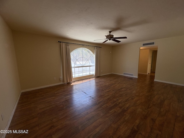 291 E Los Rincones, Green Valley, AZ 85614 - unfurnished room featuring dark wood-type flooring, visible vents, baseboards, and a ceiling fan