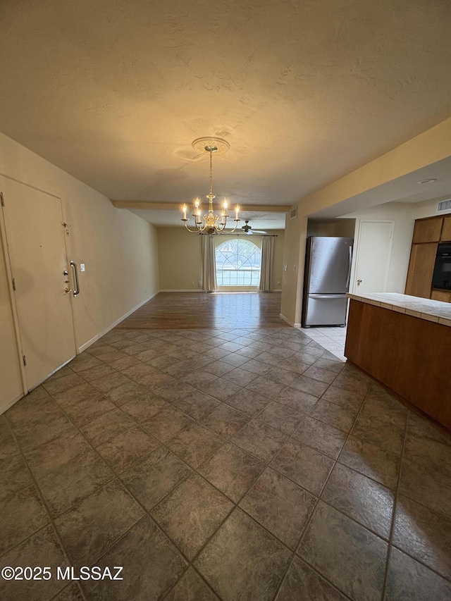 291 E Los Rincones, Green Valley, AZ 85614 - unfurnished dining area featuring visible vents, a notable chandelier, and baseboards