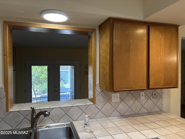 291 E Los Rincones, Green Valley, AZ 85614 - kitchen with a sink, french doors, decorative backsplash, and tile counters