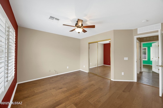 62235 E Sandlewood Rd, Tucson, AZ 85739 - unfurnished bedroom featuring wood finished floors, a closet, baseboards, and ceiling fan