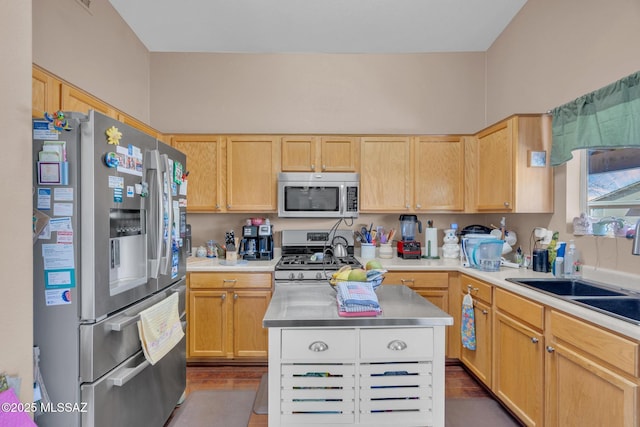 kitchen with light brown cabinets, light countertops, and appliances with stainless steel finishes