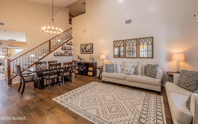 9125 S Crows Nest Ct, Tucson, AZ 85756 - living room featuring a high ceiling, stairs, dark wood-style floors, a chandelier, and baseboards