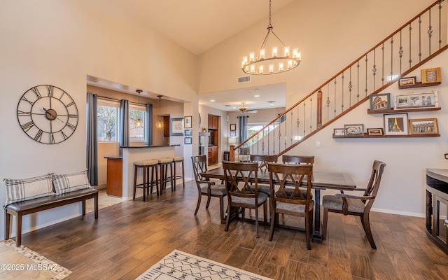 9125 S Crows Nest Ct, Tucson, AZ 85756 - dining room with a chandelier, wood finished floors, stairway, high vaulted ceiling, and baseboards