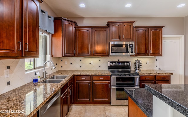 9125 S Crows Nest Ct, Tucson, AZ 85756 - kitchen with appliances with stainless steel finishes, a sink, recessed lighting, backsplash, and dark stone counters