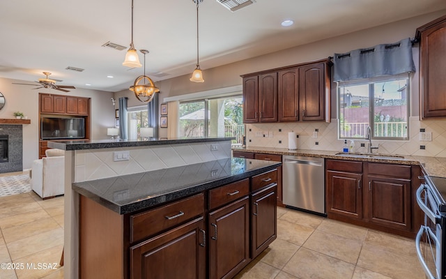 9125 S Crows Nest Ct, Tucson, AZ 85756 - kitchen with stainless steel appliances, a sink, decorative backsplash, open floor plan, and a center island