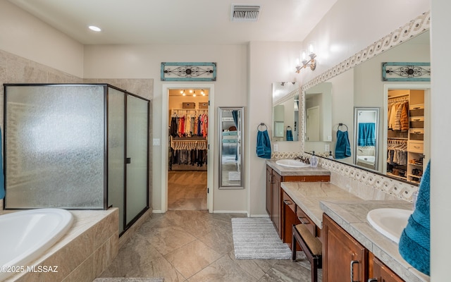9125 S Crows Nest Ct, Tucson, AZ 85756 - bathroom featuring vanity, a shower stall, a walk in closet, and a bath