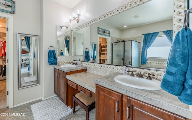 9125 S Crows Nest Ct, Tucson, AZ 85756 - bathroom with a spacious closet, double vanity, and a stall shower