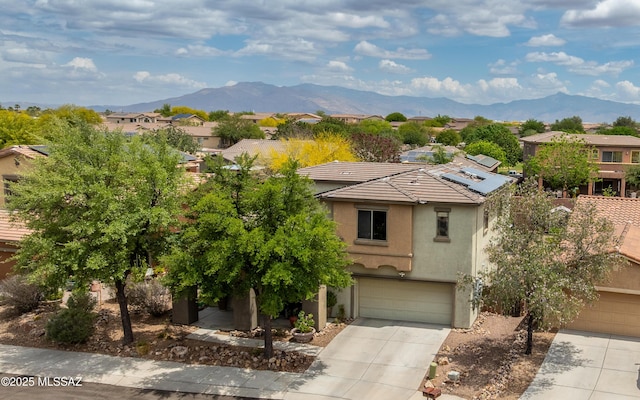 9125 S Crows Nest Ct, Tucson, AZ 85756 - view of front facade featuring stucco siding, concrete driveway, a mountain view, and a residential view