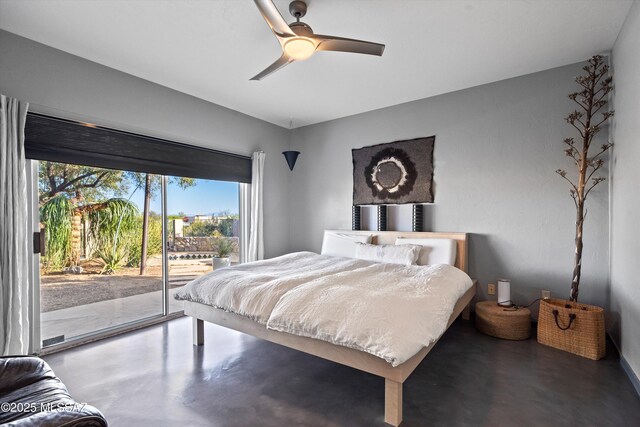 bedroom featuring finished concrete flooring, access to outside, a ceiling fan, and multiple windows