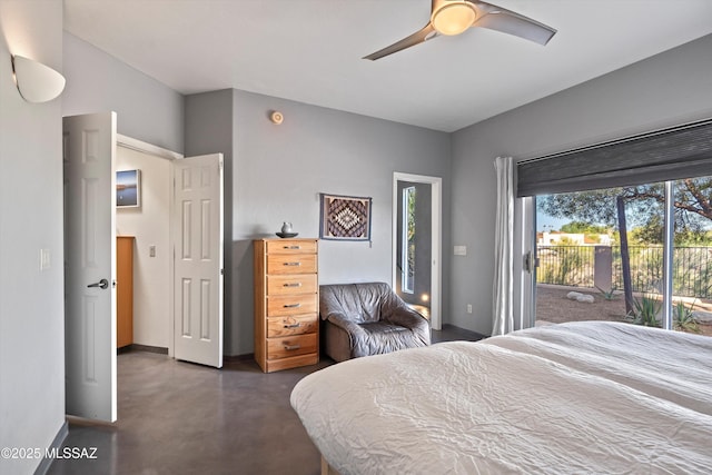 bedroom featuring baseboards, access to exterior, ceiling fan, and finished concrete floors