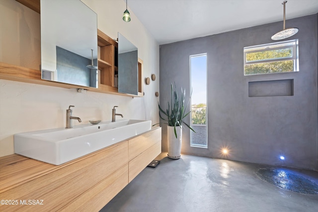 full bath with double vanity, concrete floors, a sink, and a shower