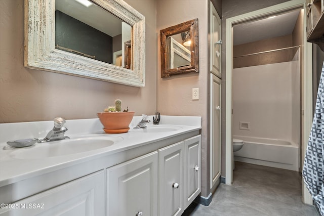 bathroom featuring a sink, toilet, double vanity, and finished concrete floors