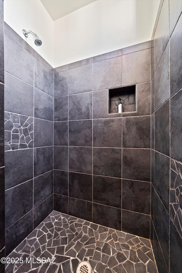 bathroom with tiled shower