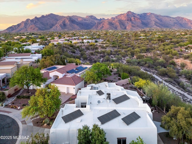 aerial view at dusk featuring a mountain view
