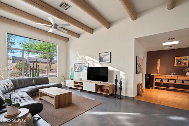 living area featuring visible vents, finished concrete flooring, beam ceiling, baseboards, and ceiling fan