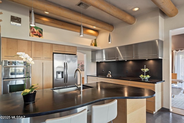 kitchen with visible vents, dark countertops, beamed ceiling, a sink, and appliances with stainless steel finishes