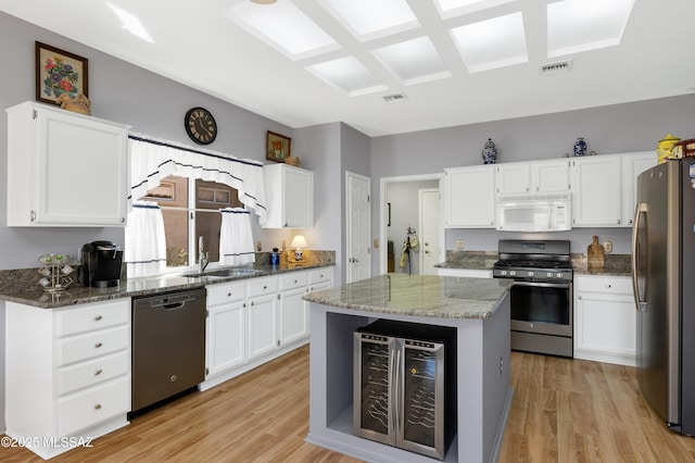 kitchen with visible vents, stainless steel appliances, light wood-type flooring, and a sink