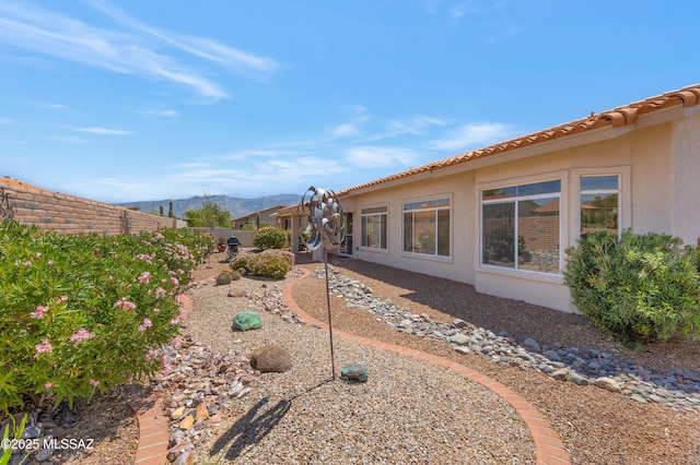 view of yard with a mountain view and a fenced backyard