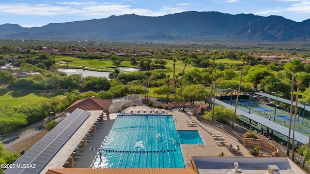 pool with a mountain view and view of golf course