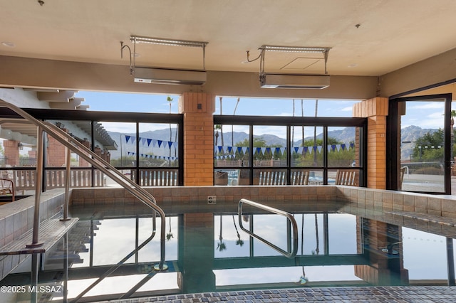 view of swimming pool with a mountain view
