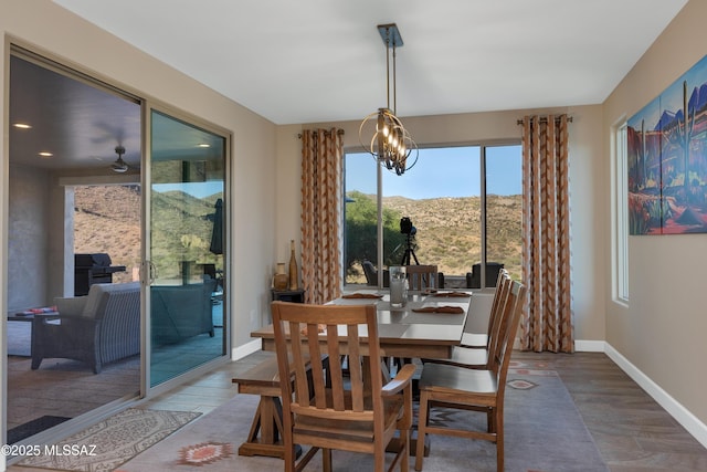 35605 S Overlook Dr, Saddlebrooke, AZ 85739 - dining room featuring a mountain view, a chandelier, wood finished floors, and baseboards