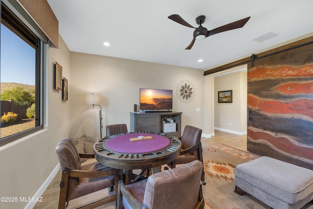 35605 S Overlook Dr, Saddlebrooke, AZ 85739 - rec room featuring ceiling fan, wood finished floors, a barn door, and visible vents