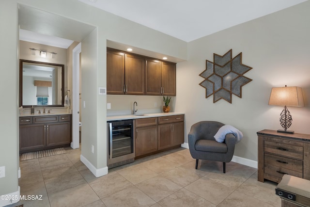 35605 S Overlook Dr, Saddlebrooke, AZ 85739 - bar featuring baseboards, beverage cooler, indoor wet bar, and a sink