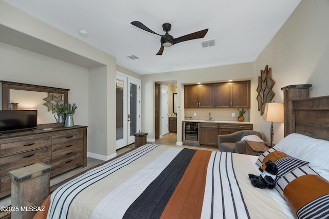 35605 S Overlook Dr, Saddlebrooke, AZ 85739 - bedroom featuring visible vents, beverage cooler, indoor wet bar, and a sink
