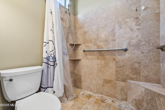 full bath featuring toilet and tiled shower