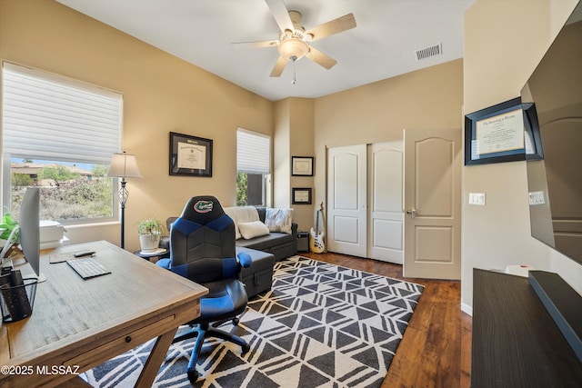 office area with ceiling fan, a wealth of natural light, wood finished floors, and baseboards