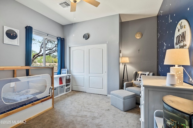 carpeted bedroom with a ceiling fan and visible vents