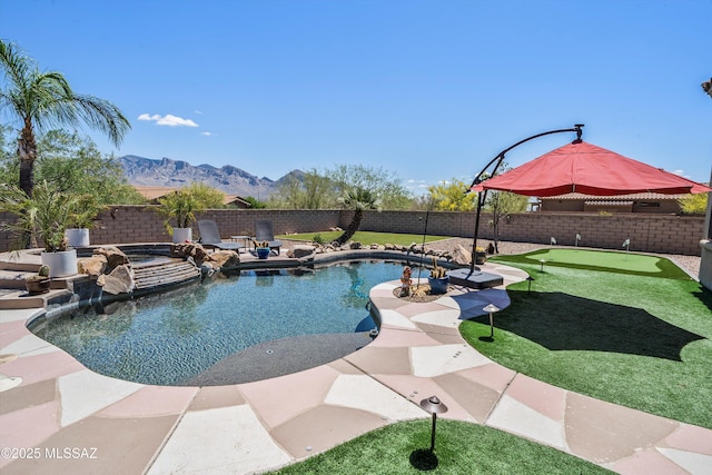 view of swimming pool featuring a fenced backyard, a mountain view, and a fenced in pool