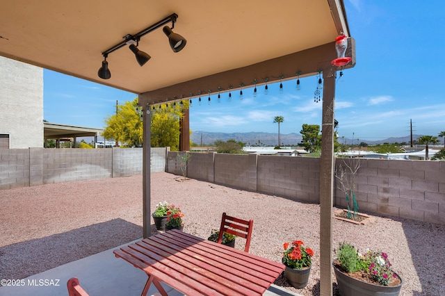 1985 S Mcconnell Dr, Tucson, AZ 85710 - view of patio / terrace featuring outdoor dining area, a fenced backyard, and a mountain view