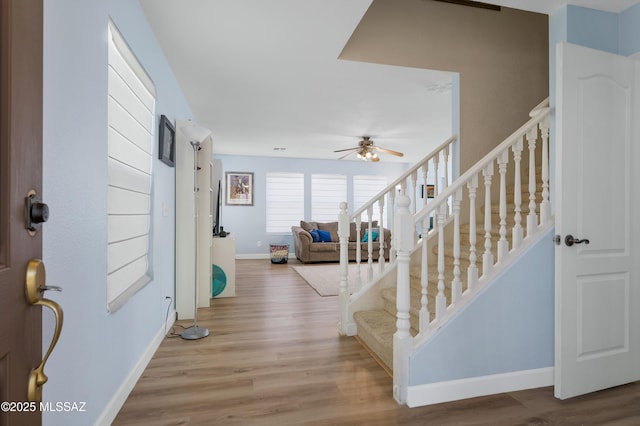 1985 S Mcconnell Dr, Tucson, AZ 85710 - foyer with baseboards, ceiling fan, light wood-style floors, and stairs