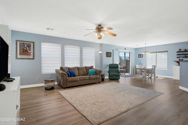 1985 S Mcconnell Dr, Tucson, AZ 85710 - living area with visible vents, ceiling fan with notable chandelier, baseboards, and wood finished floors