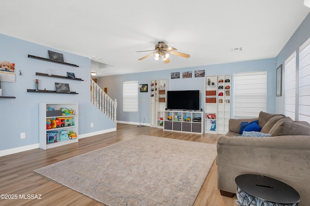 1985 S Mcconnell Dr, Tucson, AZ 85710 - living room featuring stairs, ceiling fan, baseboards, and wood finished floors