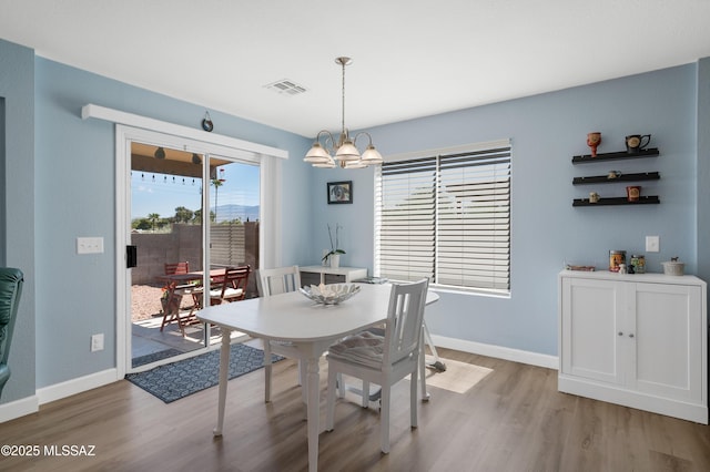 1985 S Mcconnell Dr, Tucson, AZ 85710 - dining area with a chandelier, wood finished floors, baseboards, and visible vents
