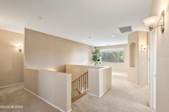 hall with visible vents, baseboards, an upstairs landing, recessed lighting, and carpet flooring