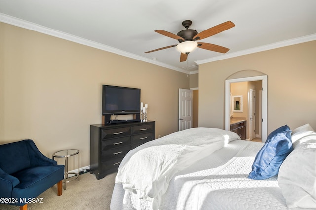 bedroom with ceiling fan, connected bathroom, light colored carpet, ornamental molding, and baseboards
