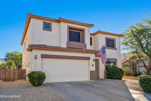 view of front of house with a garage, stucco siding, concrete driveway, and a tile roof