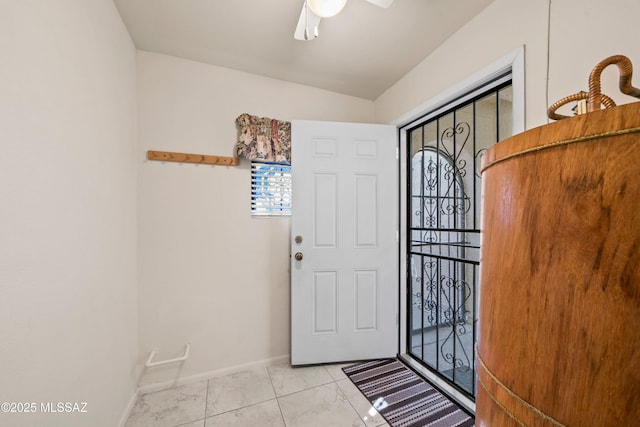 foyer featuring baseboards and a ceiling fan
