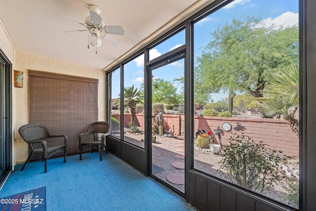 sunroom / solarium featuring ceiling fan