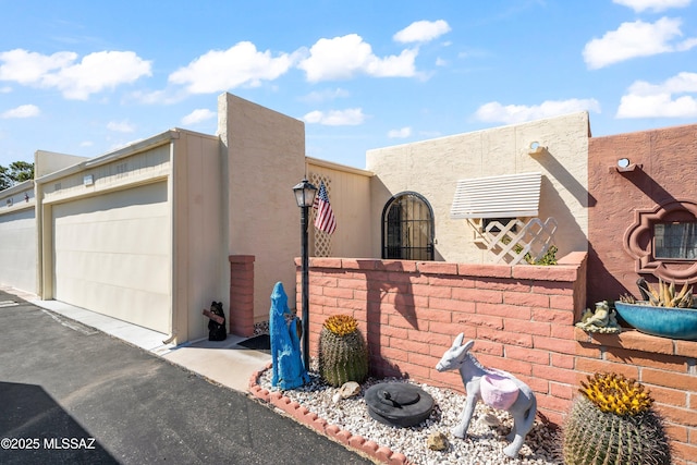 view of property exterior featuring a garage and stucco siding