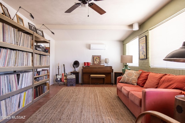 living area featuring ceiling fan and a wall mounted AC