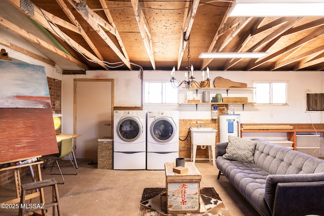washroom with a sink, separate washer and dryer, laundry area, and electric water heater