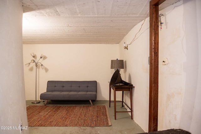 living area featuring unfinished concrete flooring