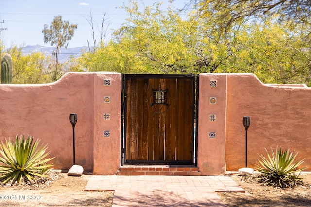 view of gate with a mountain view
